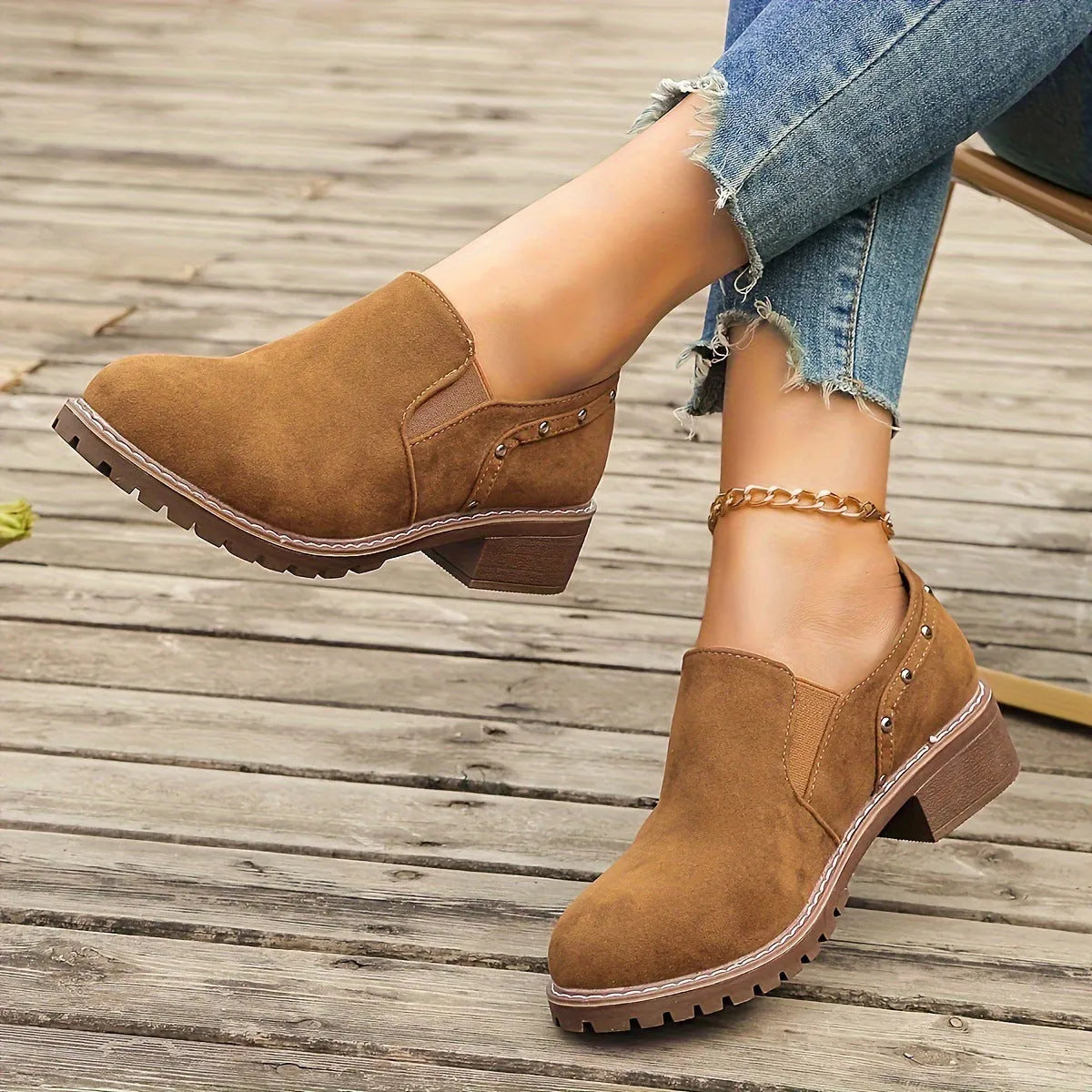 Light brown suede women's ankle boots with low heel and elastic band on a white background.