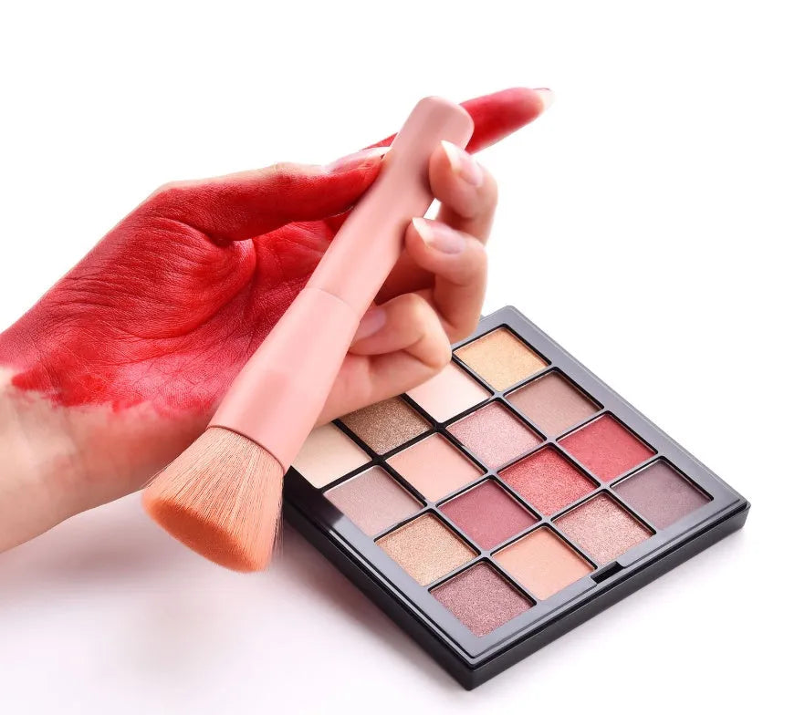 Ten professional makeup brushes with wooden handles arranged in a set, including powder, foundation and detail brushes