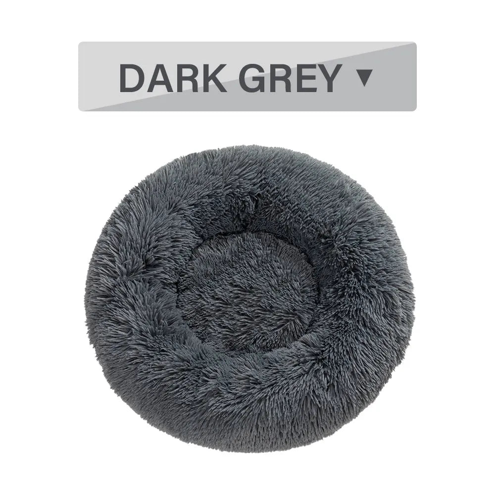 Fluffy grey donut dog bed with raised rim, shown with a small dog sleeping inside.