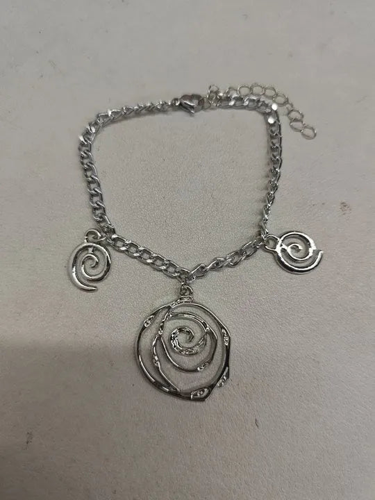 Spiral donut jewellery set showing necklace, bracelet and ear hooks in gold finish with geometric circle design