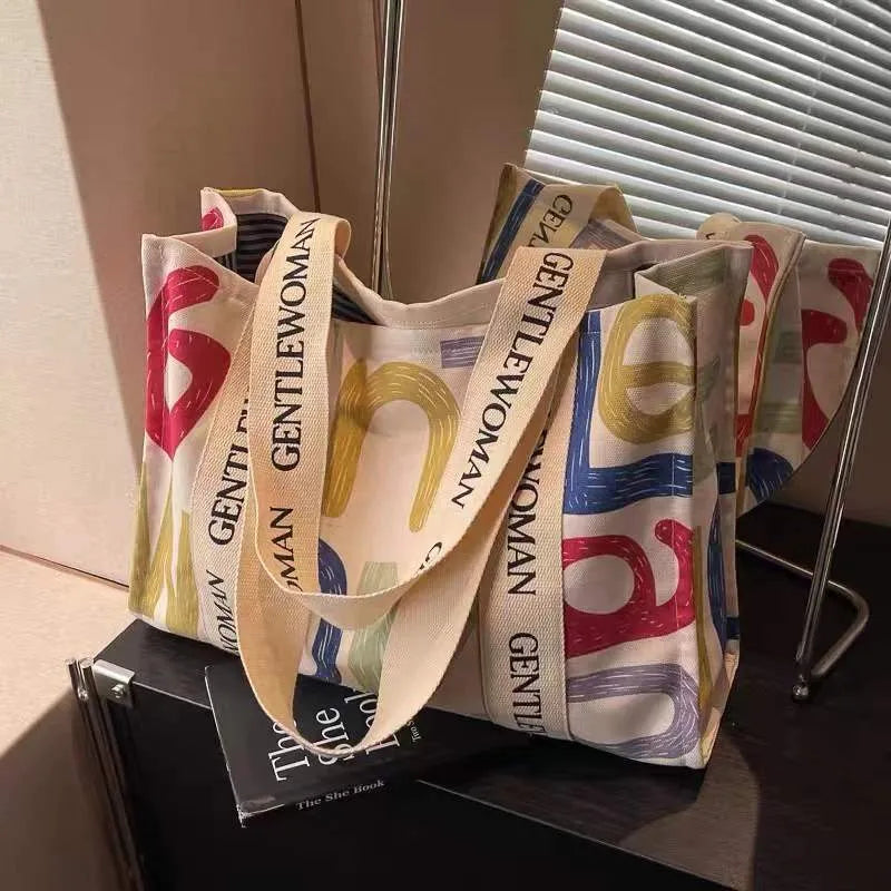 Large capacity canvas tote bag showing three design options: black letters, coloured letters, and pattern print