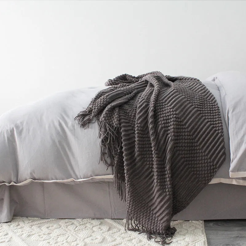 Light grey polyester nap blanket measuring 127cm by 170cm laid flat.