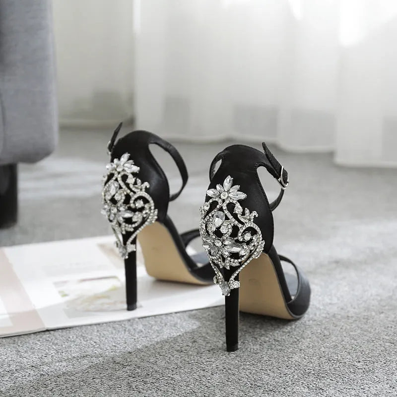 Black suede women's high heel shoes with rhinestone detail and a fish mouth toe.