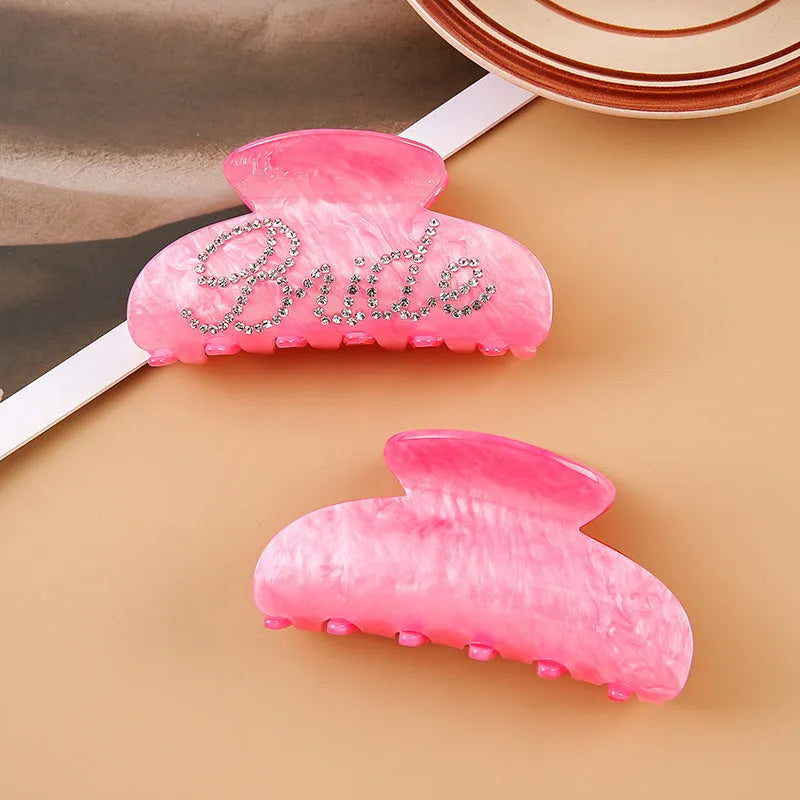 Pink and white acrylic shark clip hair barrettes with spot drill decoration on a sweet style