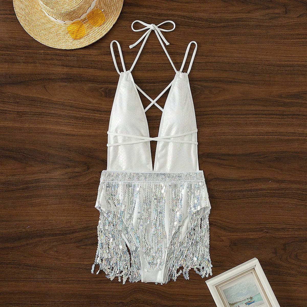 White deep V-neck women's swimsuit with tassel trim on briefs-style bottom