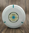Compact black and white robot vacuum cleaner on a wooden floor