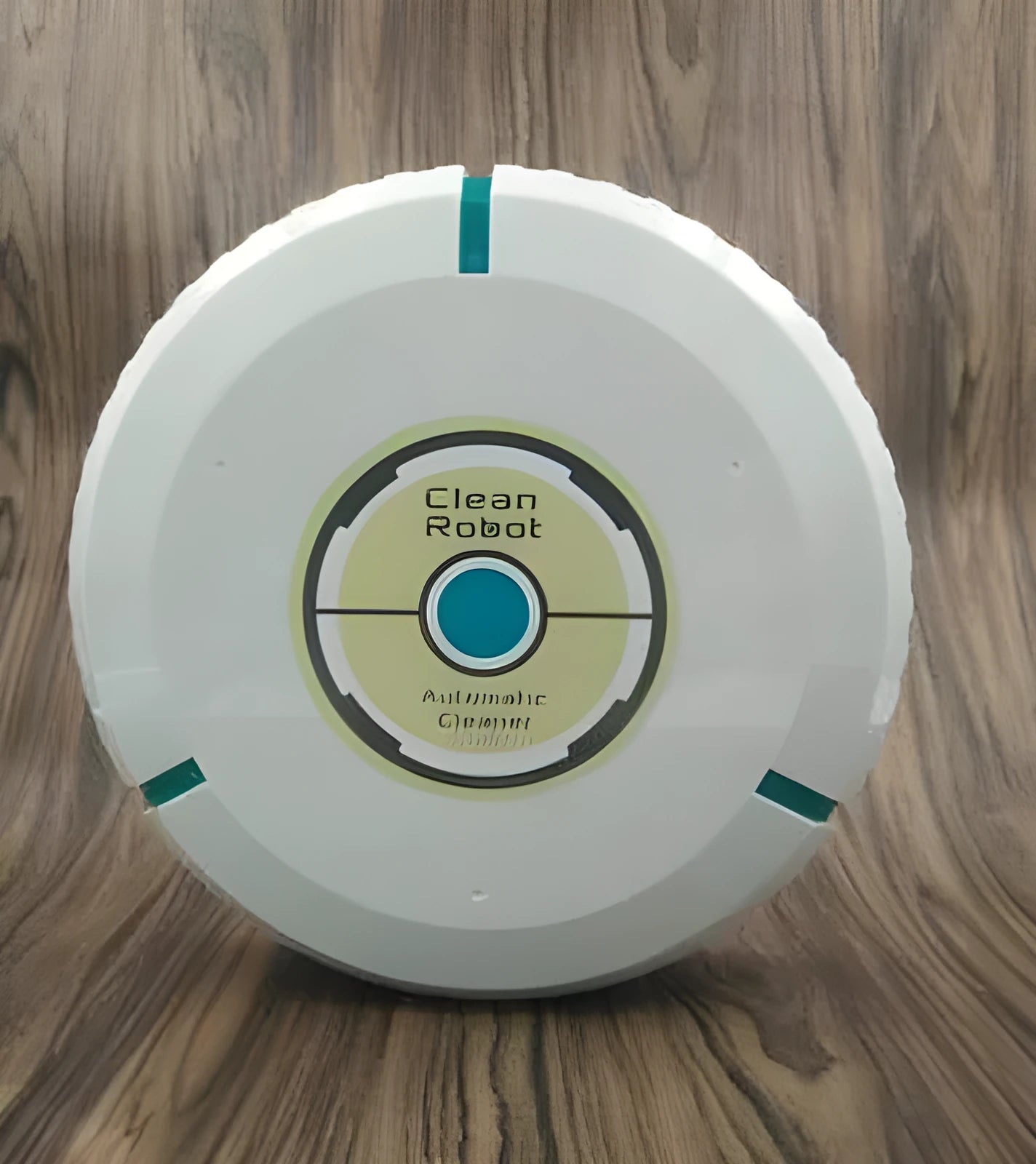 Compact black and white robot vacuum cleaner on a wooden floor