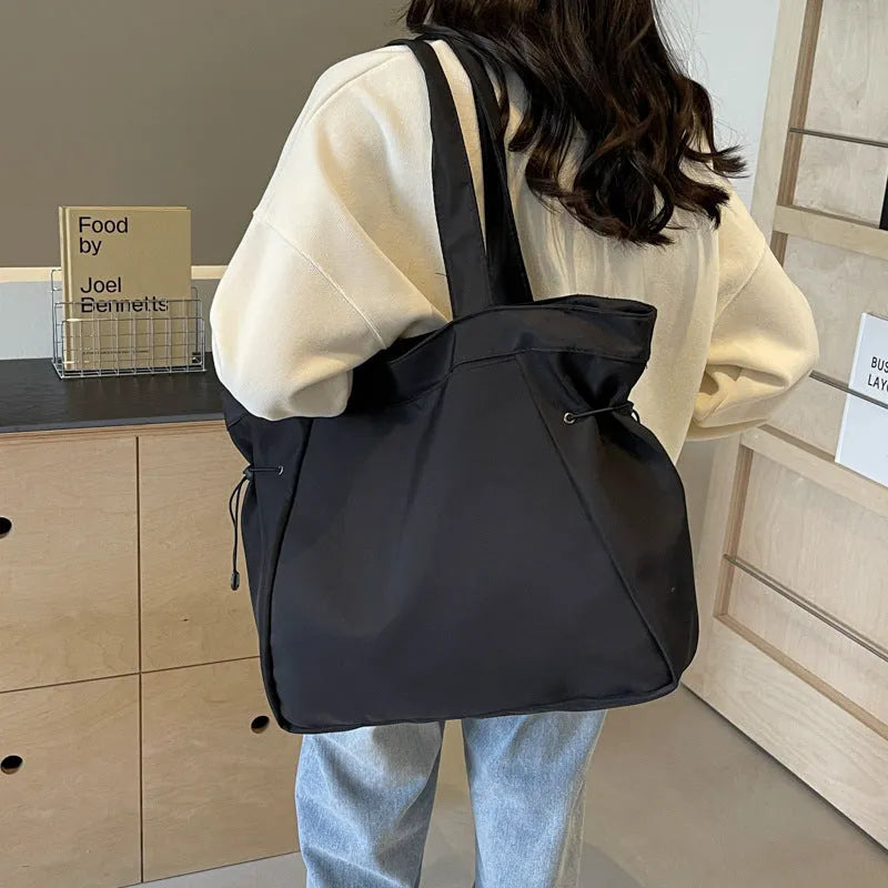 Oxford cloth folding tote bag in five colour options: black, brown, dark grey, light grey and purple.