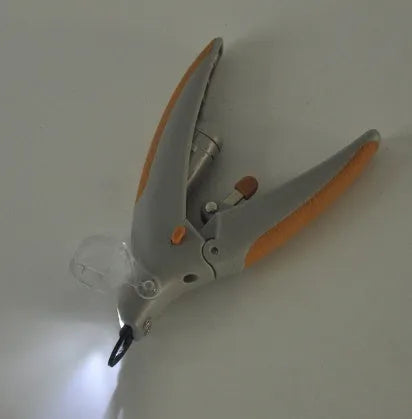White ABS plastic dog nail clipper with LED light and red imitation blood line guide.