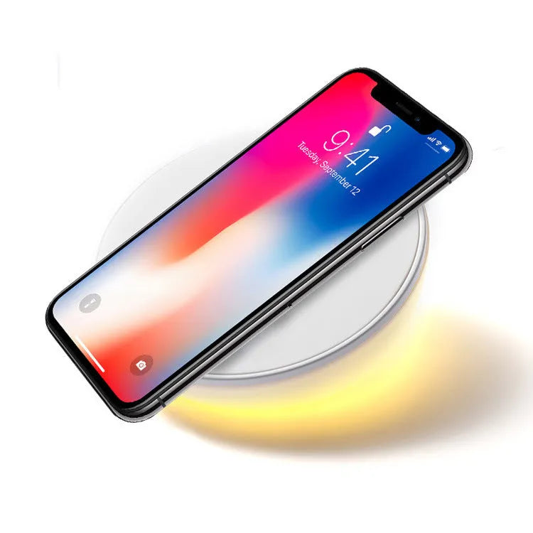 White rectangular wireless charging pad with a digital clock display on the front.