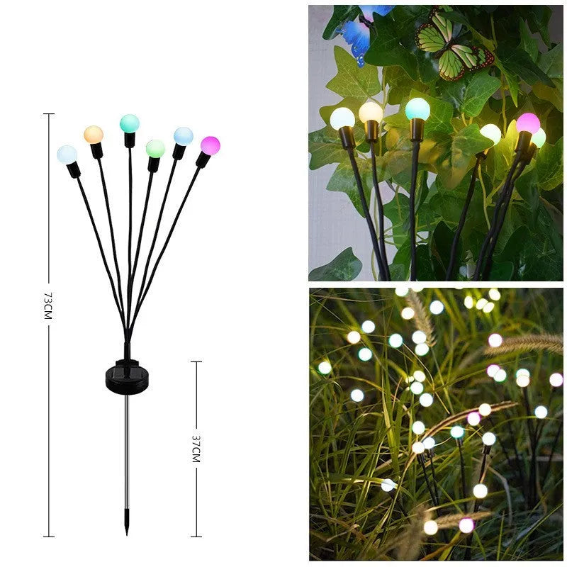 Solar-powered LED firefly garden spike light with stainless steel ground stake illuminated at dusk.