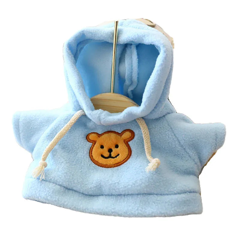 Dog wearing blue balaclava sweater with hood covering head and neck