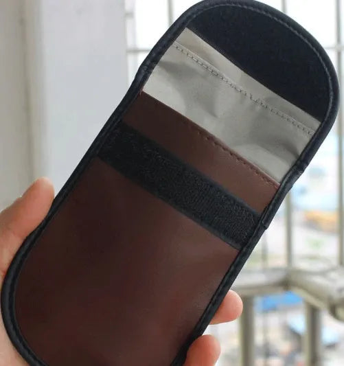 Black microfiber Faraday cage bag for blocking car key and phone signals, measuring 13.5 by 9.5 cm.