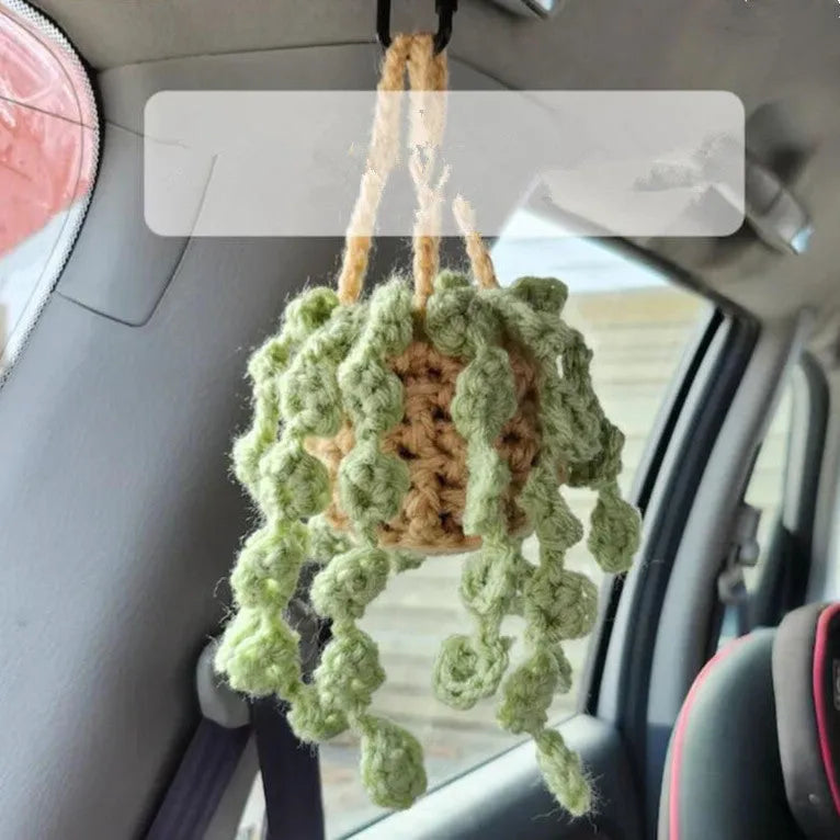 Knitted green and white car plant decoration with hanging rope
