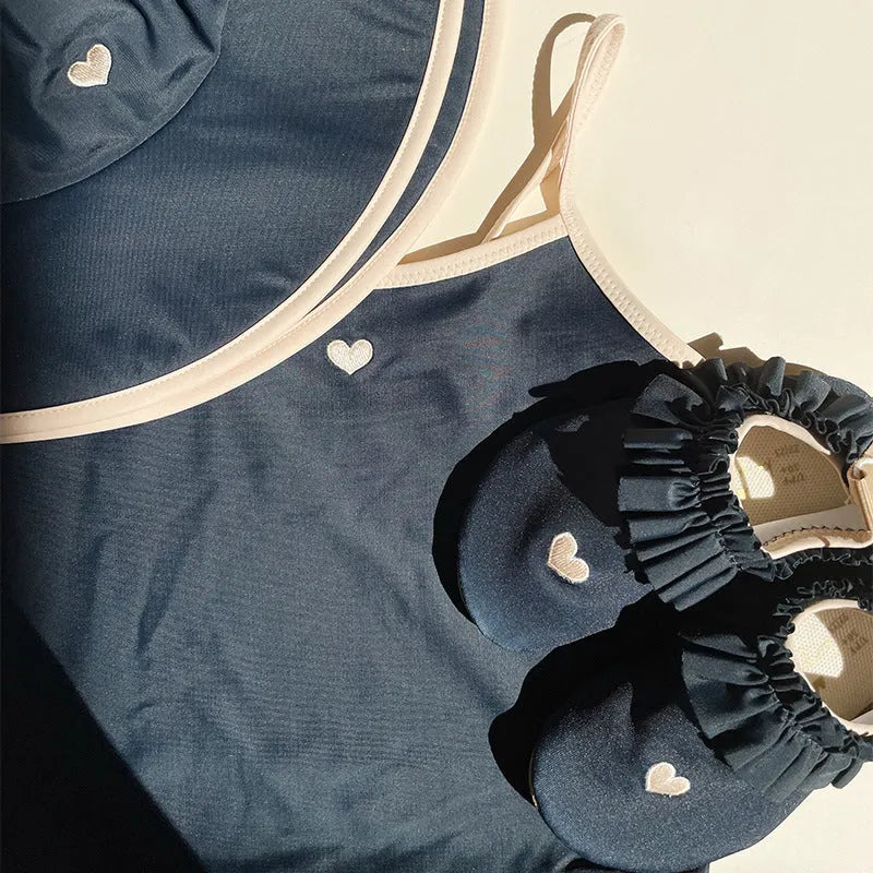 Dark blue split colour baby girls' swim briefs made from polyester and Lycra fabric.