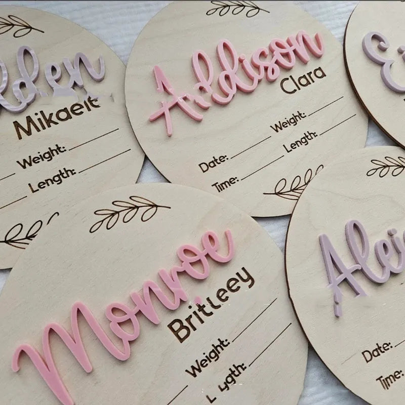 Square wooden baby name label displaying personalised birth details for nursery décor.