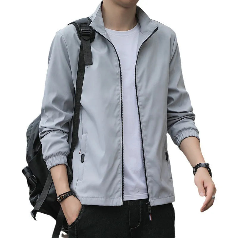 Man wearing black loose-fit Korean style autumn jacket with zip pockets