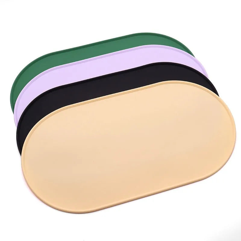 Green silicone waterproof placemat for cat bowls on a wooden floor