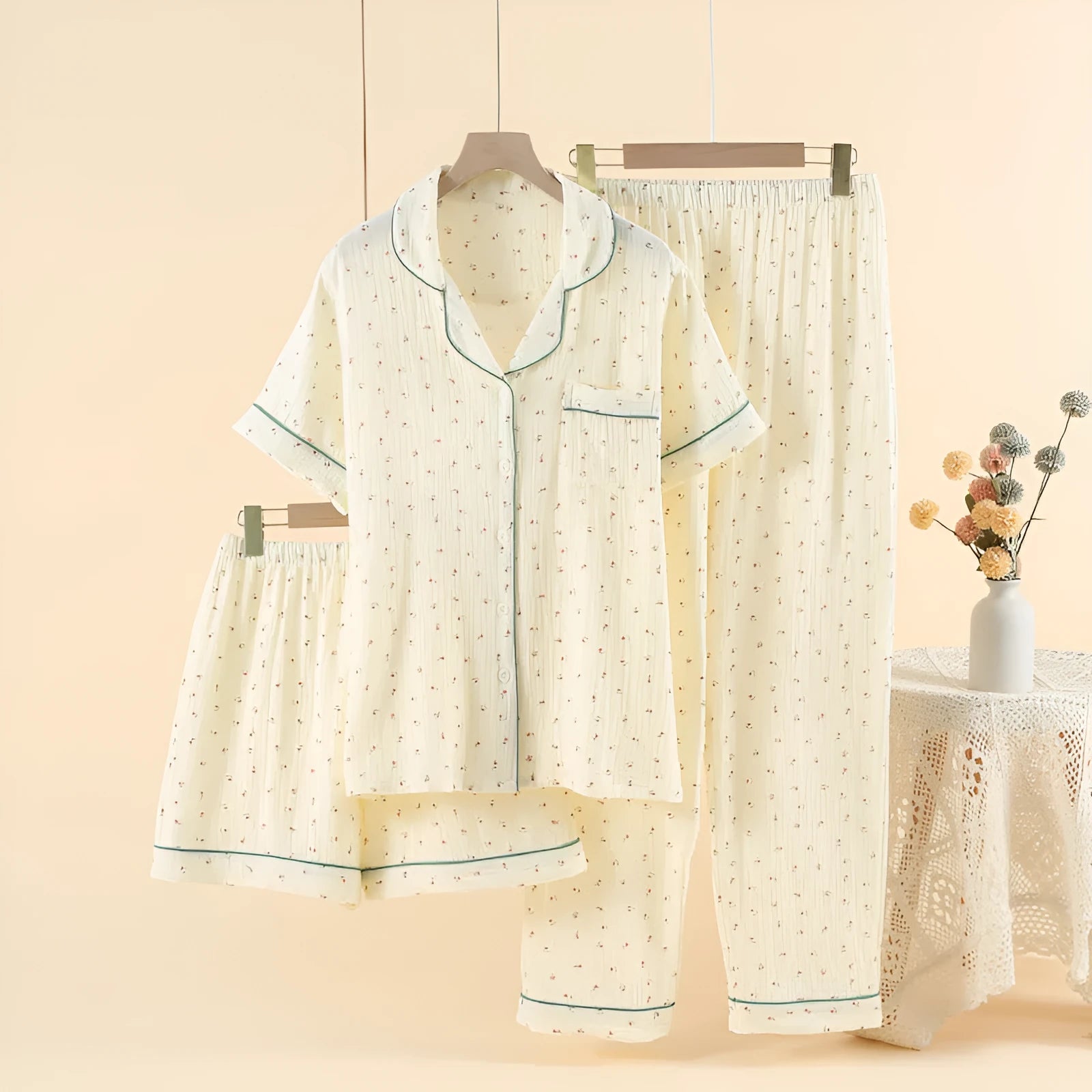 Women's cotton three-piece pyjama set with lapel top and three-quarter sleeves in a light gold colour.