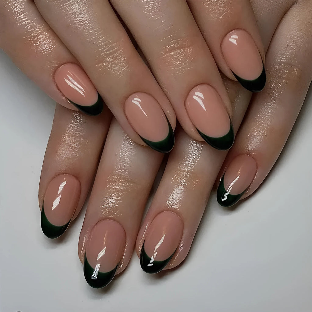 24 black French style false nails with short almond shapes laid out on a surface.