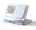 Black and white wireless charging station with phone, watch, and headphones on dock, showing LED time and temperature display.