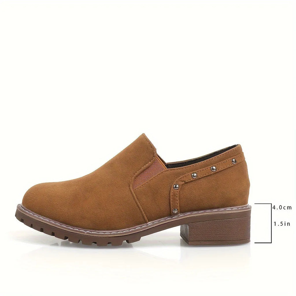 Light brown suede women's ankle boots with low heel and elastic band on a white background.