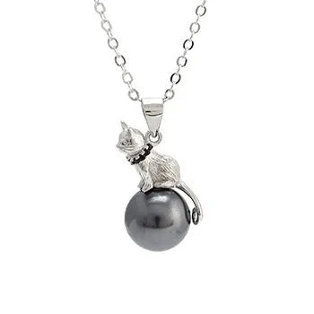 Close-up of a sterling silver cat pendant on a clavicle necklace chain.