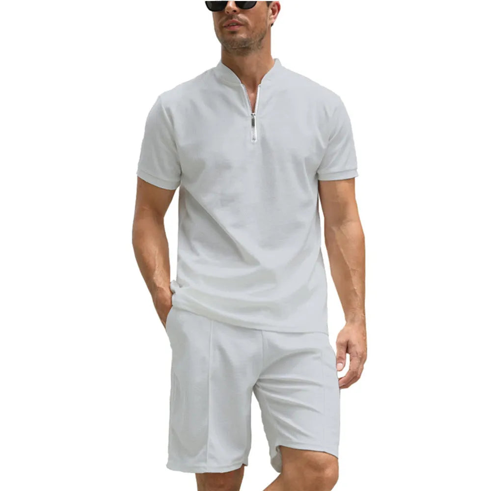 Men's solid colour short sleeve polo shirt and trousers two-piece set on a hanger.