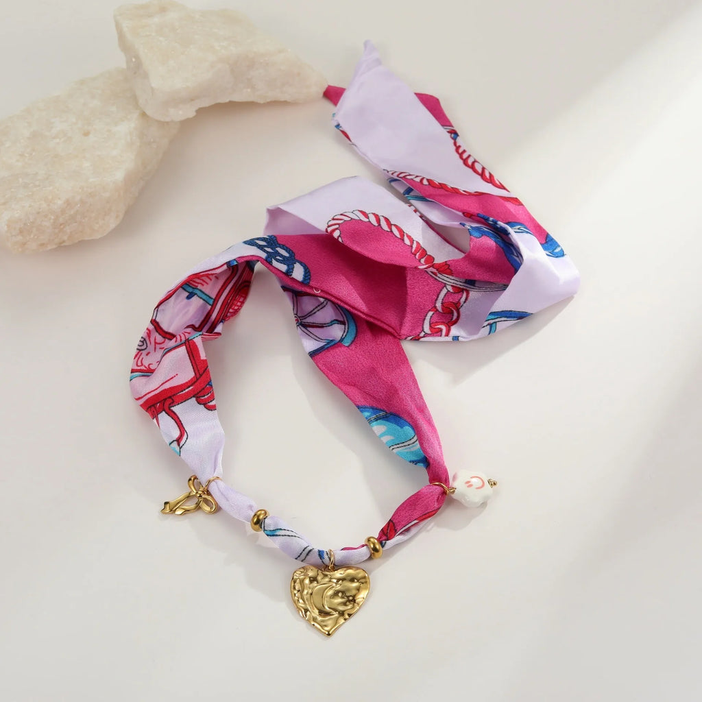 Women's geometric chain necklace and bracelet set with colourful pendant on a white background.