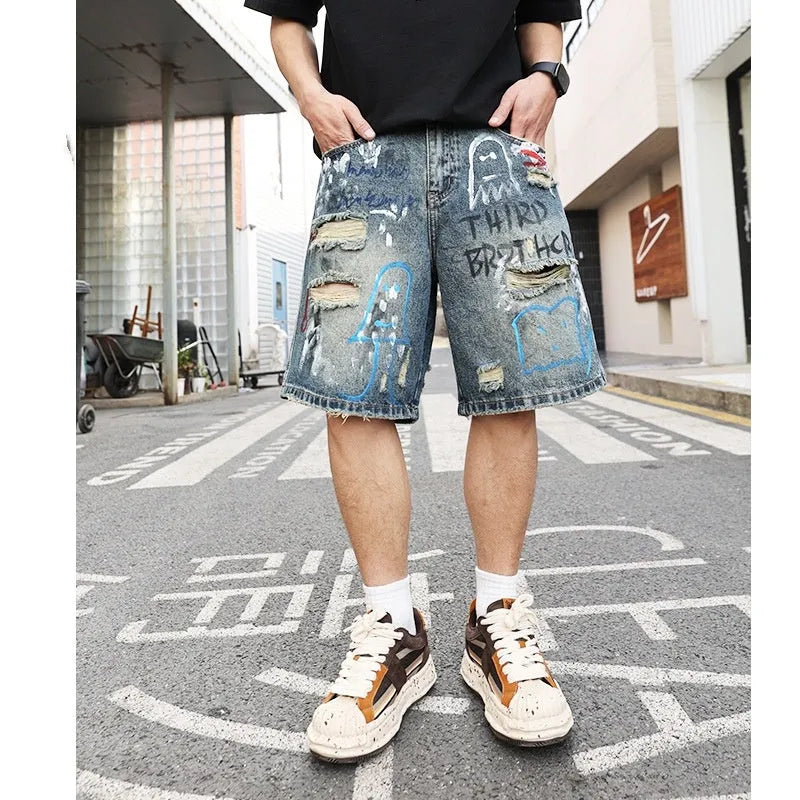Blue ripped men's denim shorts with graffiti design and zipper fly