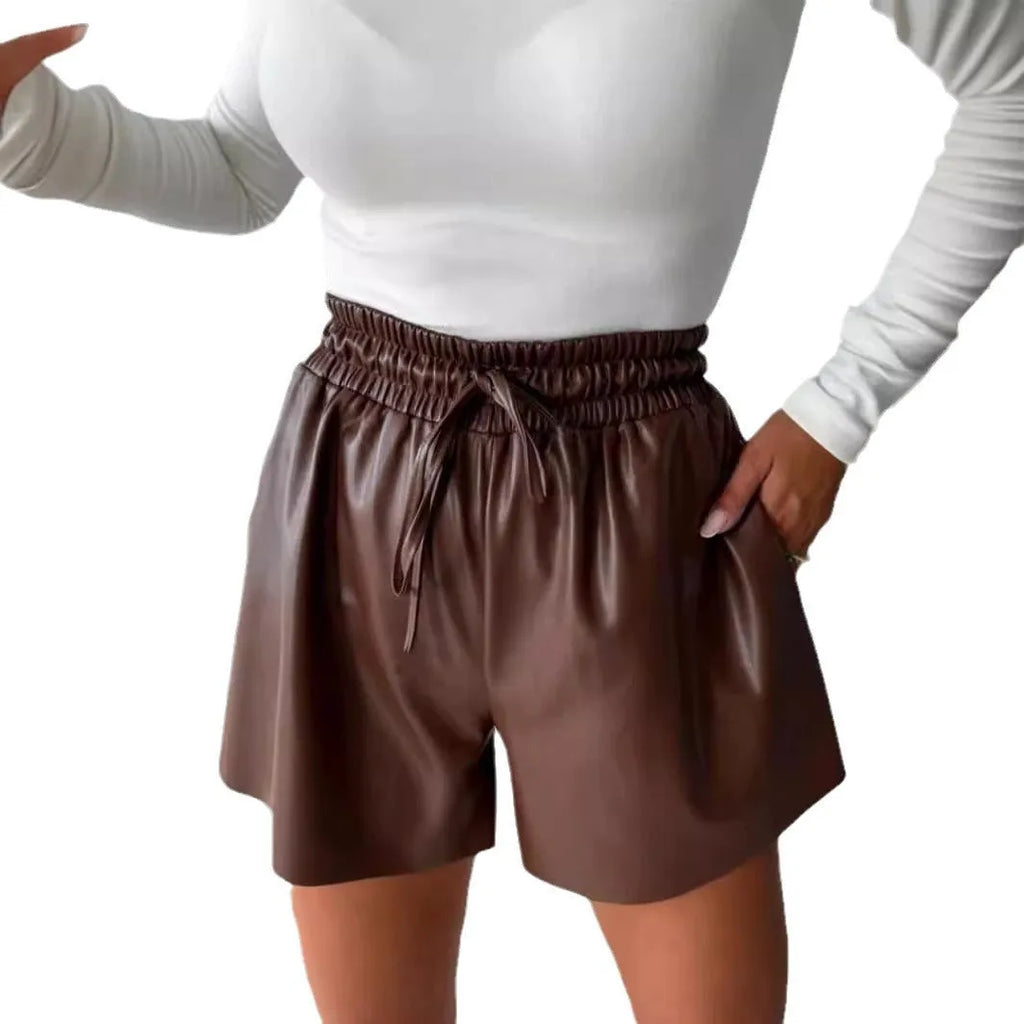 Women's black wide-leg casual shorts with a drawstring lace-up waist detail on a mannequin.