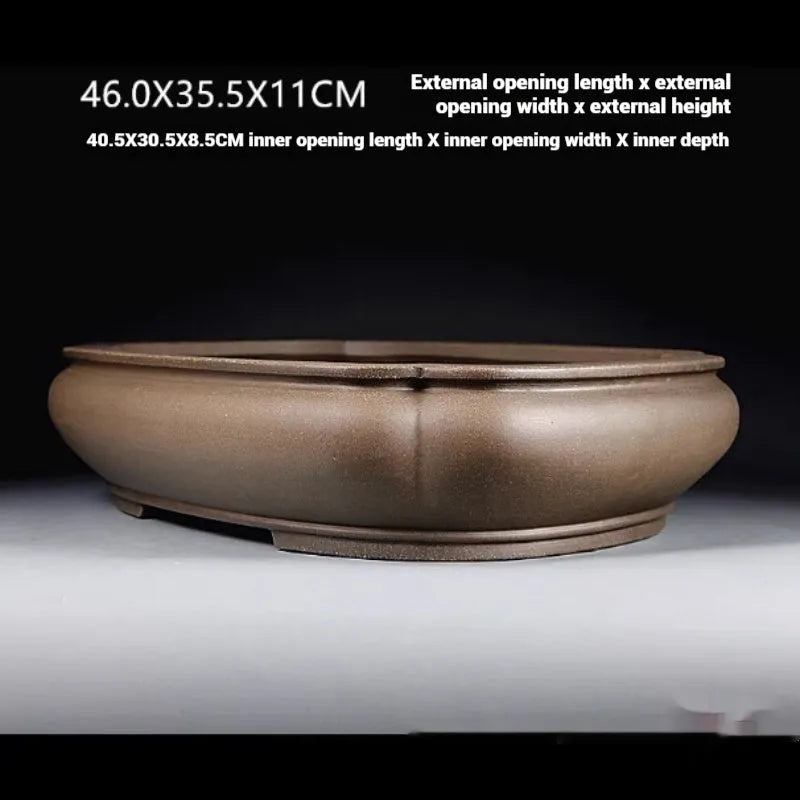 Handmade antique purple clay papaya-shaped flower pot on a tabletop