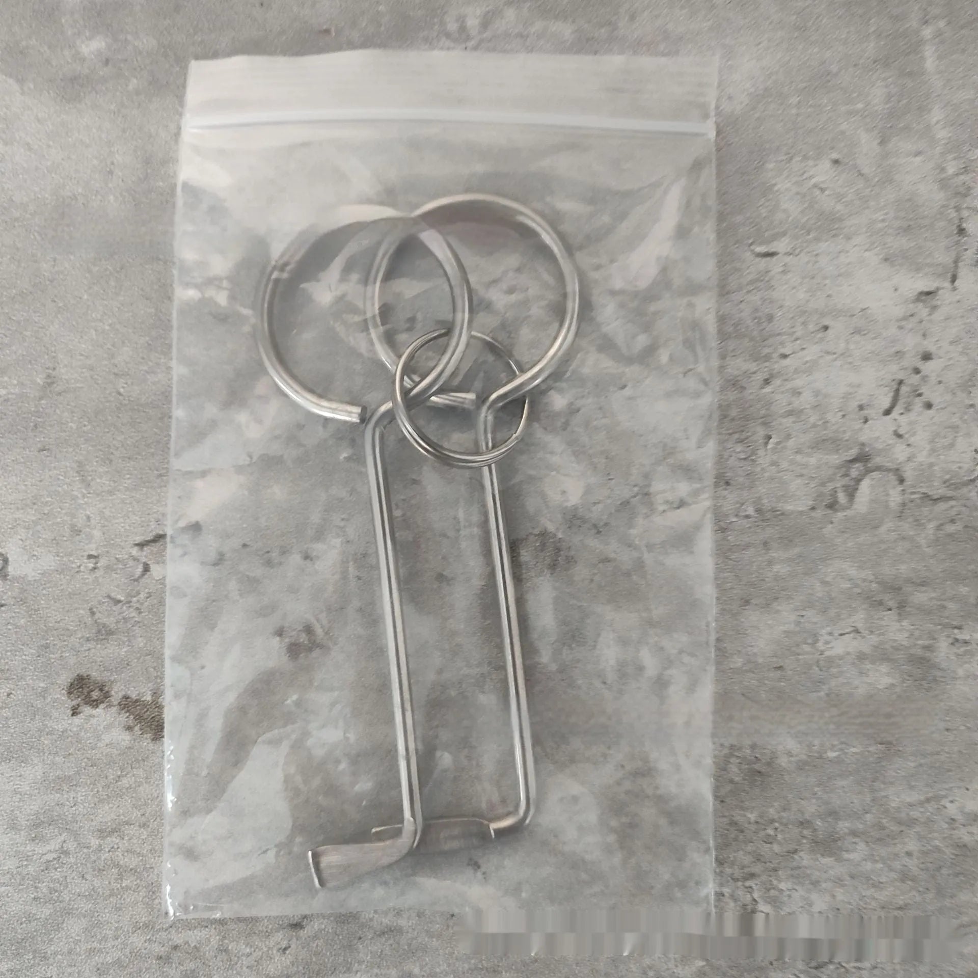 Two silver alloy wrench tools from a portable universal tool set.