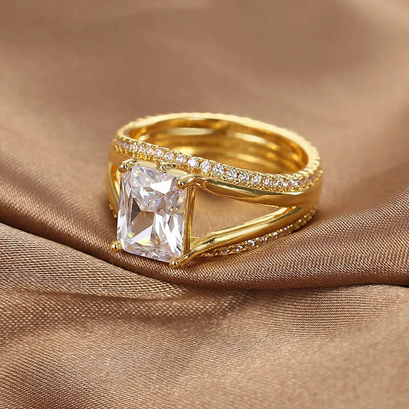 Gold-coloured geometric women's copper ring with a square zircon stone.