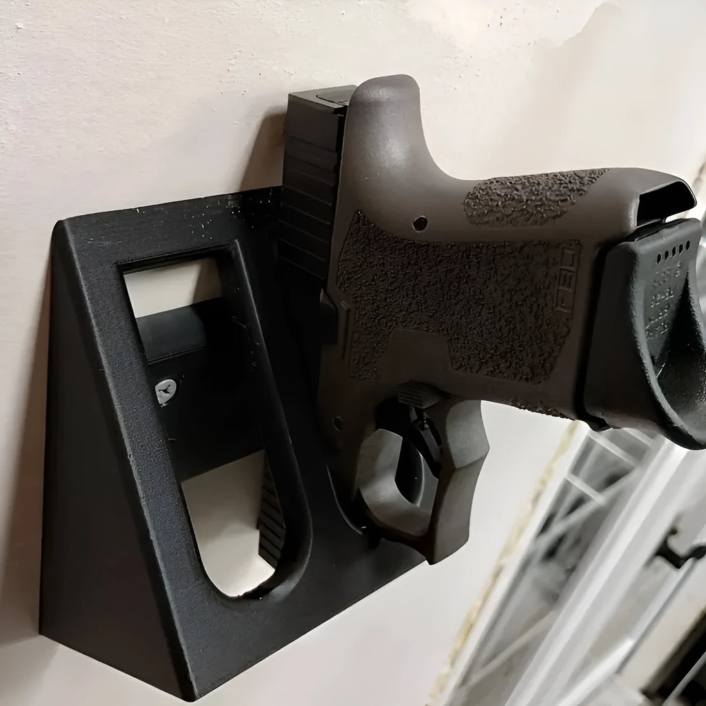 Black punk-style plastic stand for displaying a toy pistol.