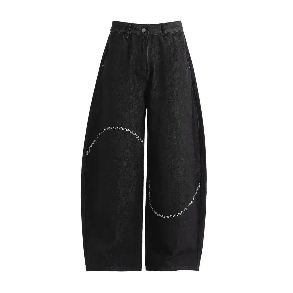 Black straight-leg denim trousers with mid-waist zip fly design on hanger