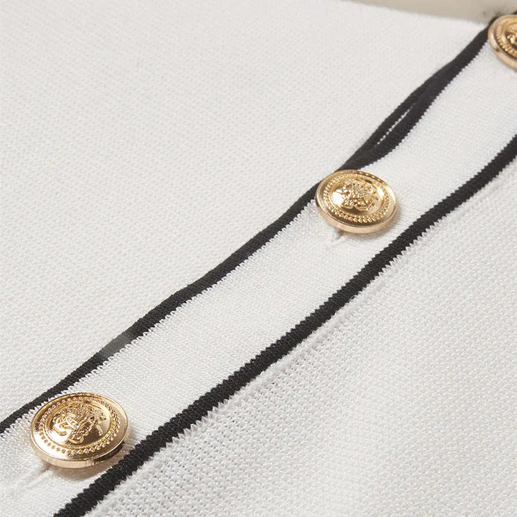 White short sleeve cardigan with dark contrast lapels on a hanger