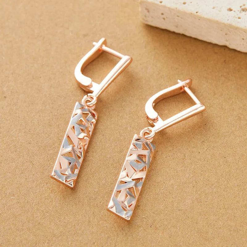 Rectangular two-tone hollow stud earrings with geometric design and silver electroplated finish