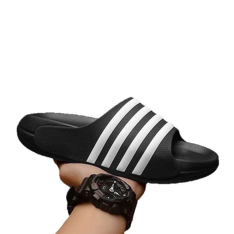 Casual unisex slippers with a light EVA sole and a structured PVC upper, shown in a neutral colour.