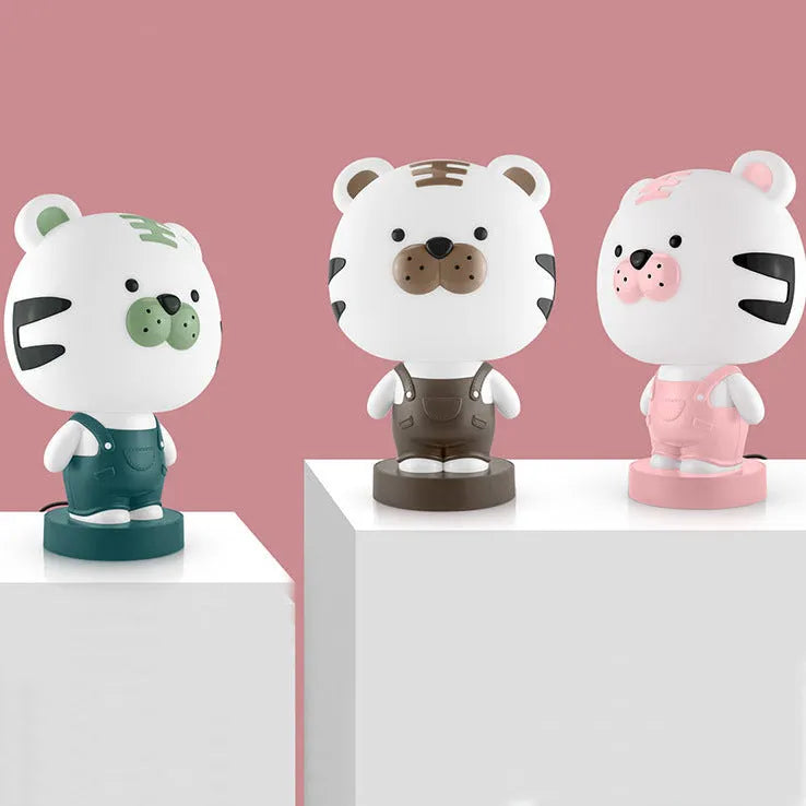 Cartoon animal table lamp in bear, cow, rabbit, or tiger design with plastic shade and LED light.