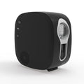 Black laser star projector lamp projecting colourful nebula patterns on wall