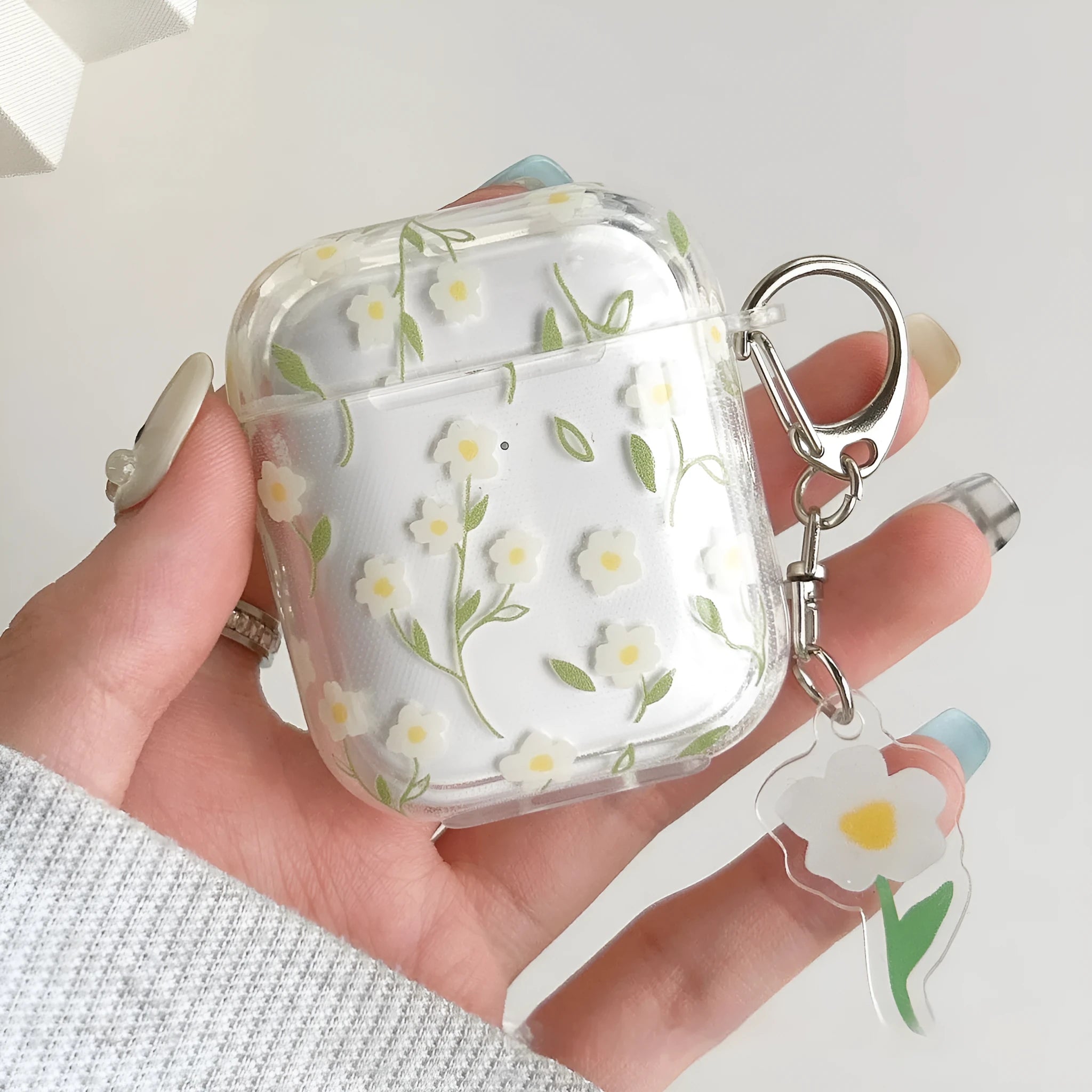 Transparent TPU AirPods case cover with white floral design showing compatibility with multiple Apple AirPods models