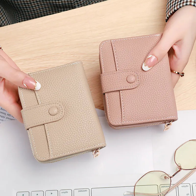 Ladies short PU wallet with lychee pattern in beige, pink, black, or red colour.
