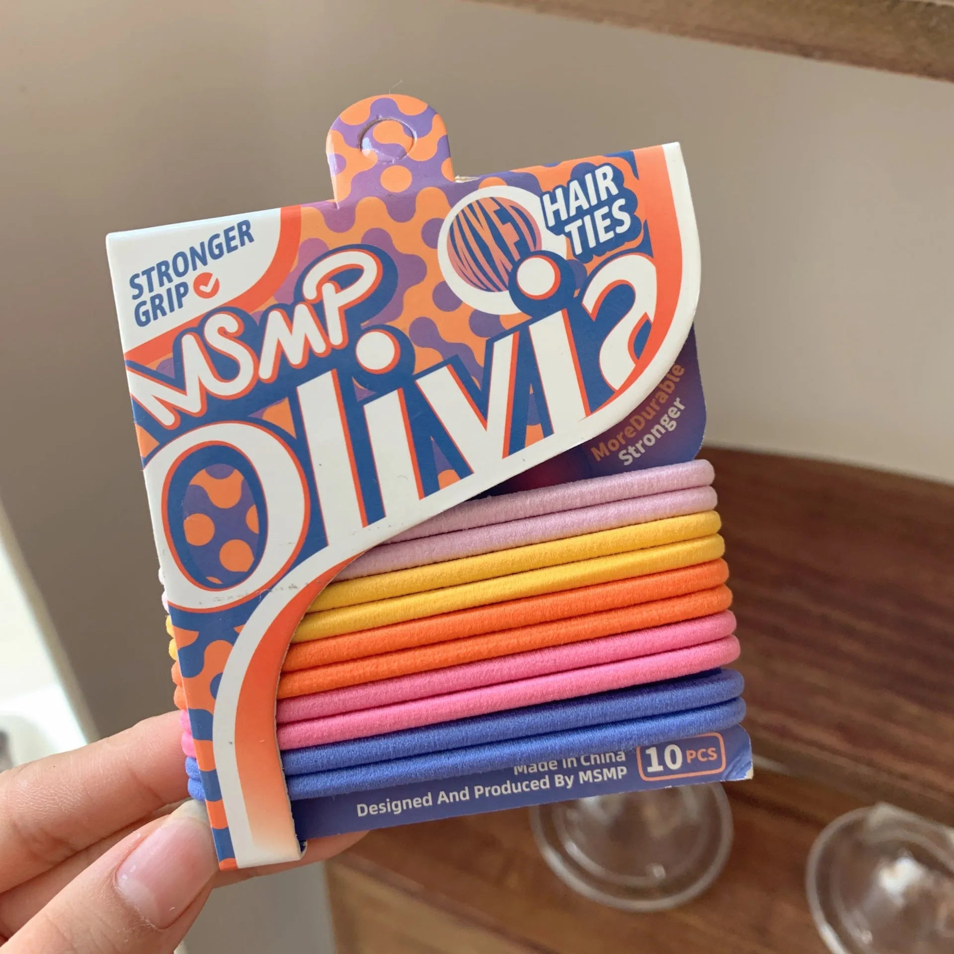 Set of braided elastic hair bands in assorted candy colours on a white background.