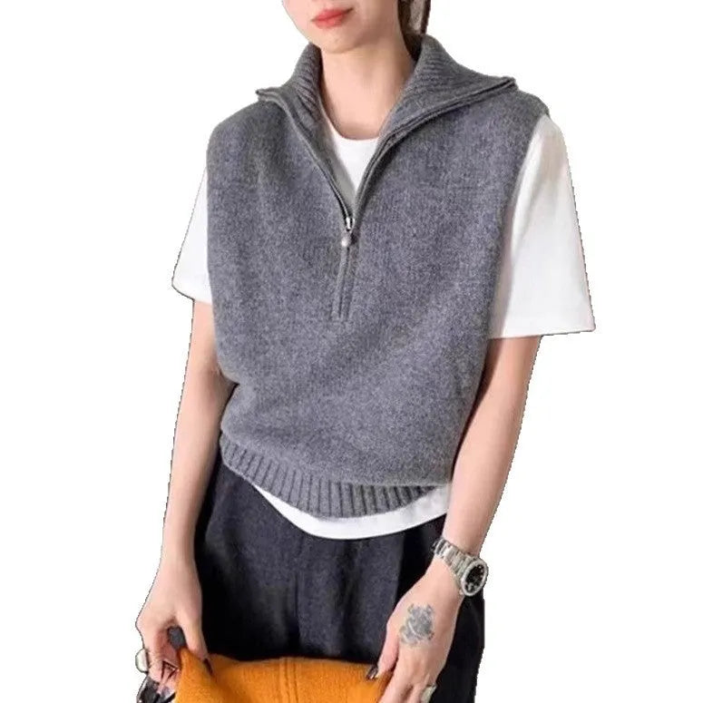 Orange sleeveless half-zip mesh knit vest on a hanger, casual style.