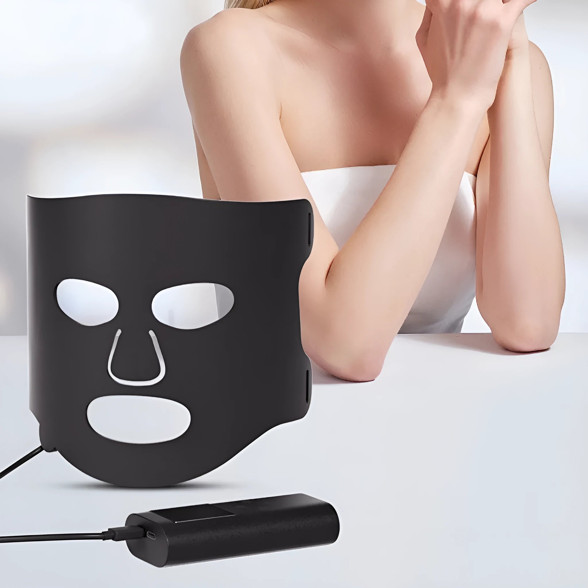 White and black LED phototherapy face mask with adjustable strap and controller for home skin light therapy