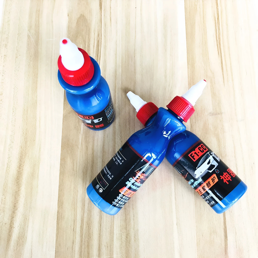 Blue car wiping tool with microfiber applicator and scratch repair agent bottle for automotive paint damage