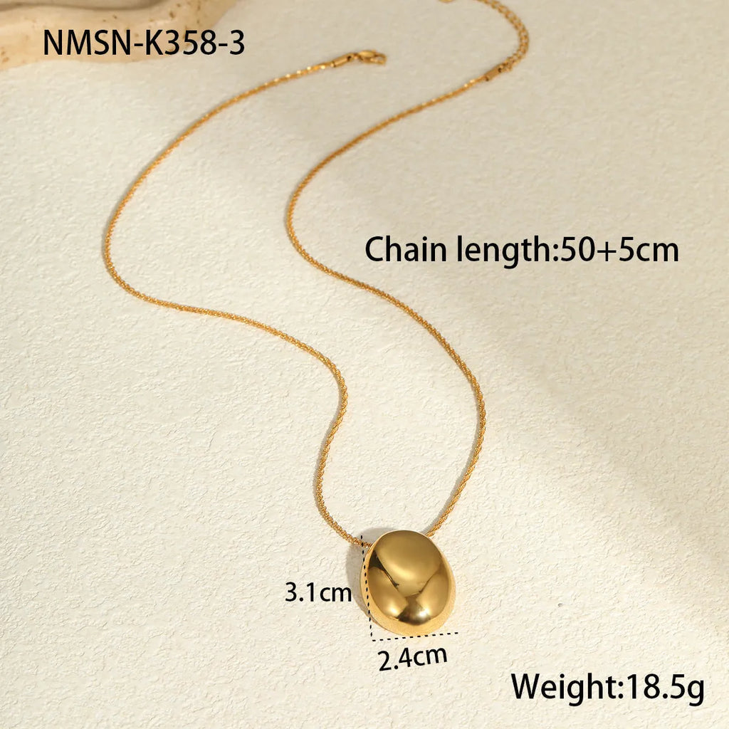 Gold geometric pendant necklace with adjustable chain on white background
