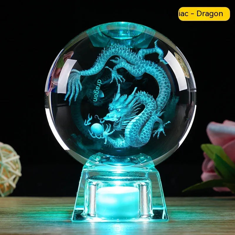 White luminous crystal ball ornament with Chinese zodiac animal figure on electronic base.
