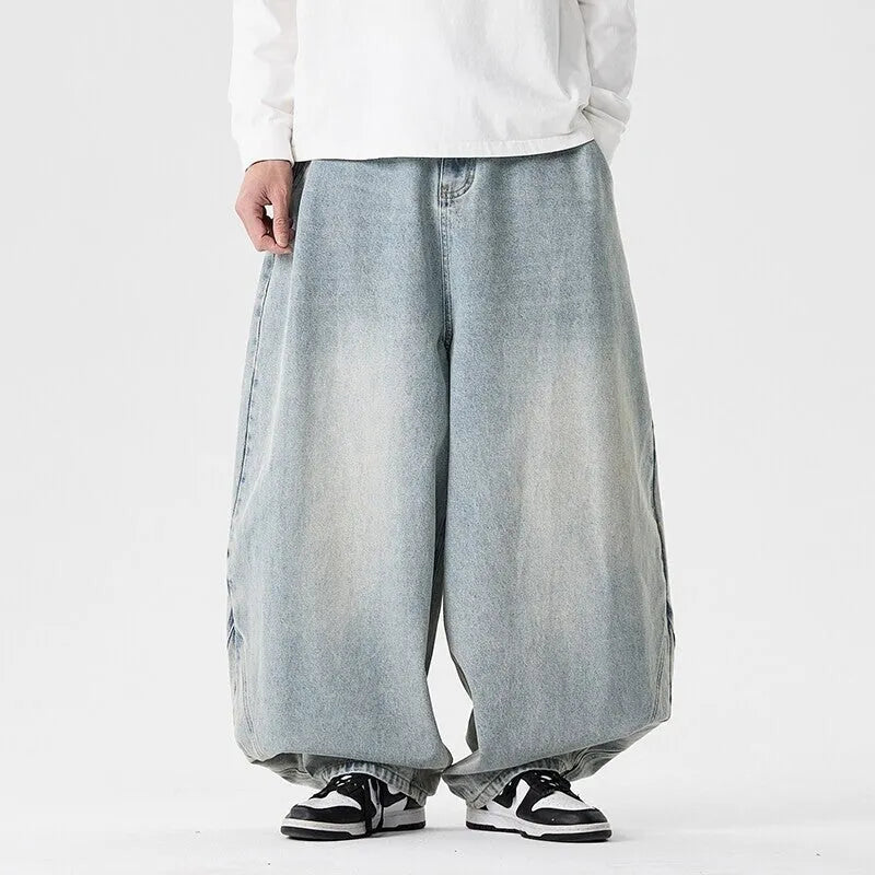 Men's plus size light blue wide leg baggy denim jeans with a low waist and straight leg opening.